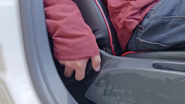 Twisting the seat clockwise to lift the backrest up.