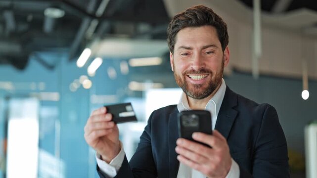 Business professional feels delighted making secure digital purchase. Satisfaction using phone credit card, modern e-commerce convenience. Positive financial interaction, bringing happiness to task.