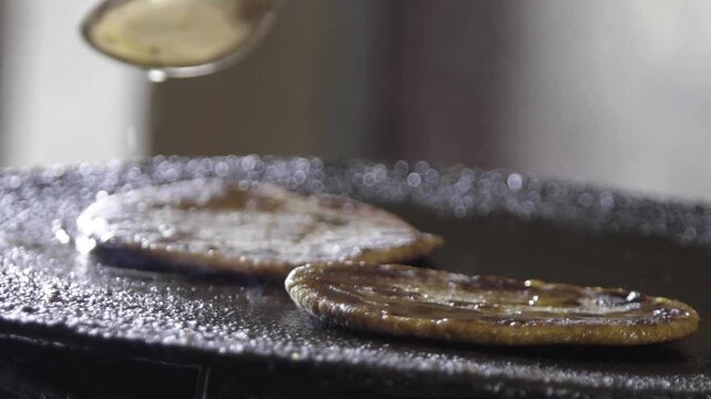 Closeup shot of cooking Parantha on Pan. Local grain Bajra Roti.