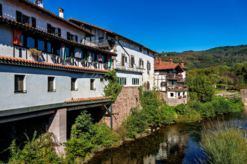 Walking through the streets of Elizondo, Navarra, Spain. Traditional Basque houses with classic red and white facades
