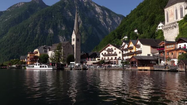 Aerial floating shot of hallstatt village lakefront in austria