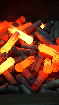 Red-hot forged parts in a heap after mass production.