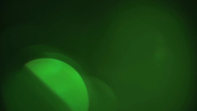 light leak and bokeh overlay with green hues, capturing soft glowing circles and lens flares. This footage is ideal for adding atmospheric effects to videos.