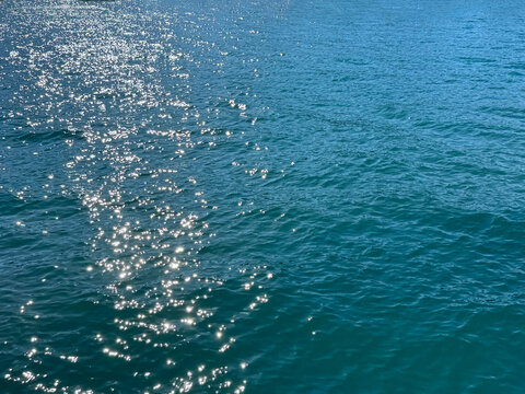 Ocean sea blue water with sun glares.