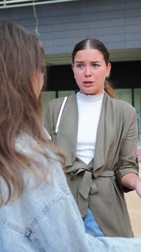 A woman shows her emotions while engaging in a serious conversation, illustrating the complexities of interpersonal communication and emotional expression during a conflict or disagreement.