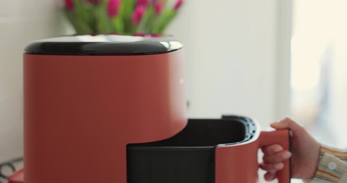 Close-up of air fryer in kitchen - concept of preparing a healthy dessert. Smart device at home kitchen.