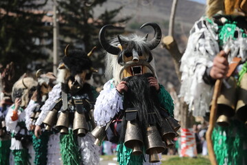 Zemen, Bulgaria - March 15, 2025: Masquerade festival Surva in Zemen, Bulgaria. People with mask called Kukeri dance and perform to scare the evil spirits.