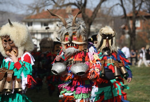 Zemen, Bulgaria - March 15, 2025: Masquerade festival Surva in Zemen, Bulgaria. People with mask called Kukeri dance and perform to scare the evil spirits.