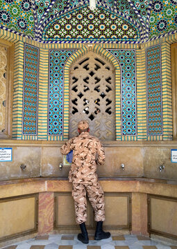 Soldier taking water at a fountain at the shah-e-cheragh mausoleum, Fars province, Shiraz, Iran