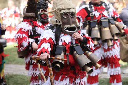 Zemen, Bulgaria - March 15, 2025: Masquerade festival Surva in Zemen, Bulgaria. People with mask called Kukeri dance and perform to scare the evil spirits.