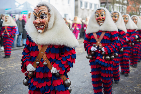 Traditional costumes with wooden masks (Blaetzlesbuaba from Ergenzingen) during the Swabian-Alemannic carnival ("Schw&auml;bisch-Alemannische Fasnet") at a parade at Hirschau near Tuebingen, Baden-Wuerttem
