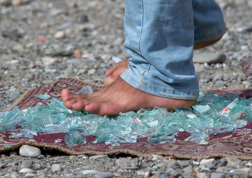 Man walking on broken glass, Hormozgan, Minab, Iran