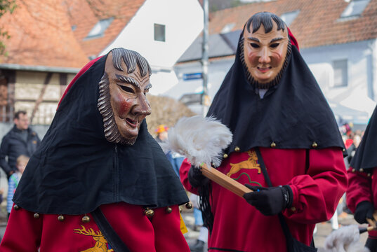 Traditional costumes with wooden masks during the Swabian-Alemannic carnival ("Schw&auml;bisch-Alemannische Fasnet") at a parade at Hirschau near Tuebingen, Baden-Wuerttemberg