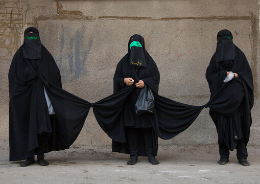 Iranian shiite women with knotted veils to walk together during the fourty pulpit ceremony Ashura, Lorestan, Khorramabad, Iran