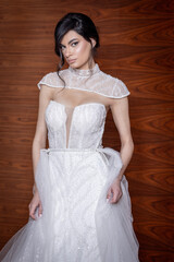 Young bride posing elegantly in a wedding gown