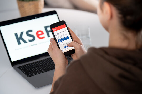 KSeF Krajowy System e-Faktur logo and website on a smartphone and computer screen. Government e-Invoicing tax platform for issuing, receiving invoices on February 17, 2026 in Krakow, Poland.