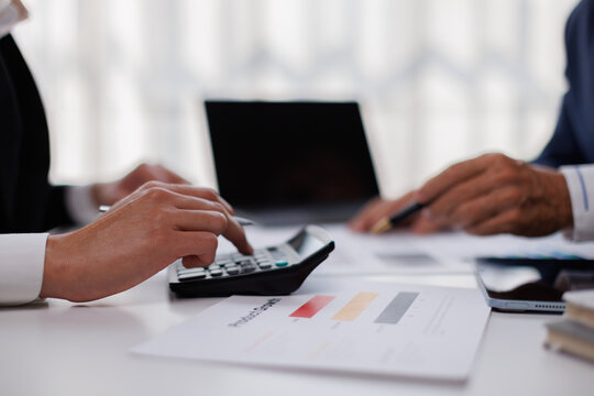 Auditor and accountant team working in office, analyze financial data and accounting record with calculator. Accounting company provide finance and taxation planning for profitable cash flow. 