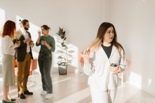 Woman feeling excluded during office coffee break