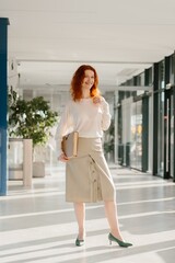 Obraz premium Professional woman walking through modern office corridor