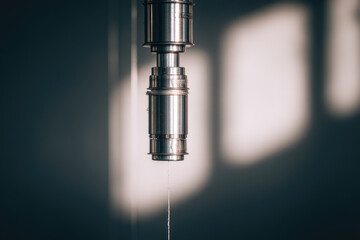 Stainless steel machinery part in sustainable textile factory with soft sunlight, industrial equipment detail, modern manufacturing process, clean and precise environment