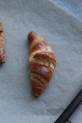 butter croissants
 on parchment photographed from above