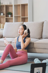 Obraz premium Young Asian sporty attractive people practicing yoga lesson with instructor. Asia group of women exercising healthy lifestyle in fitness studio. Sport activity, gymnastics or ballet dancing class.
