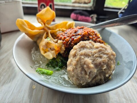 Indonesian Meatball Soup (Bakso) with Fried Wonton and Spicy Sambal Sauce.