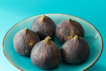 Bowl with fresh ripe purple figs fruit