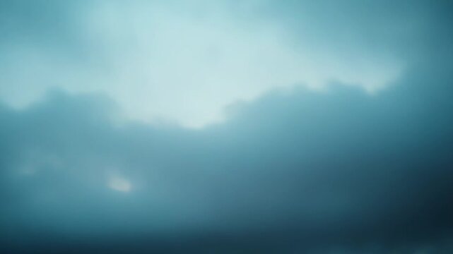 Abstract clouds form a soft, dreamy gradient of blue and white, creating a tranquil and ethereal sky background with a soothing, atmospheric effect for multiple uses