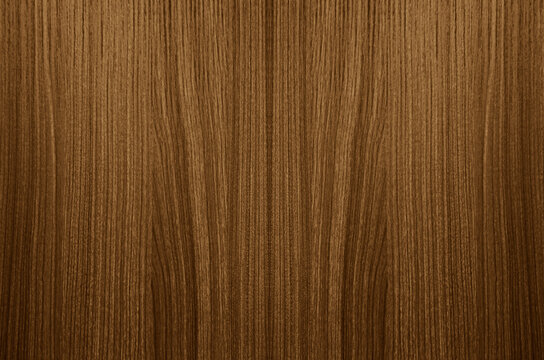 Superlative nut veneer background in stylish brown tone. Natural wood texture, pattern of a long veneer sheet, plank. Dark amber polished wood with intricate grain pattern and textured finish
