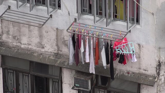 Drying laundry on outside rack at old government subsidized housing complex in Hong Kong

