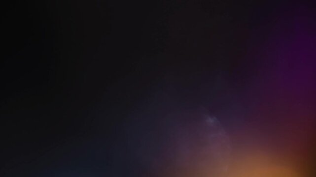 Light leak and bokeh overlay with a dark background and colorful flares. This video can be used as a transitional effect or to add atmosphere to footage.