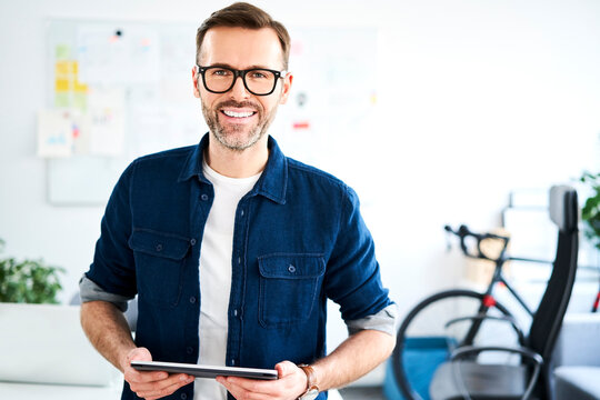 Portrait of smiling businessman in office