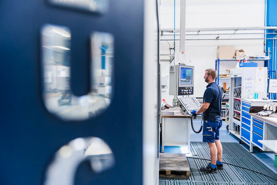 Man operating machine in industrial factory