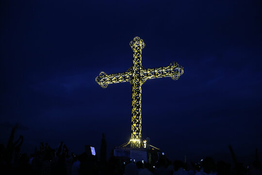 Large illuminated metal cross on a hilltop at night in Adigrat, Tigray, Ethiopia