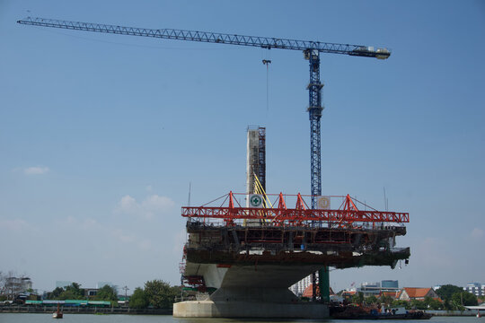 Bangkok, Thailand: February 1, 2026: Large scale construction of a new concrete bridge crossing the Chao Phraya River in the Kiak Kai area located directly near the Parliament Building. 