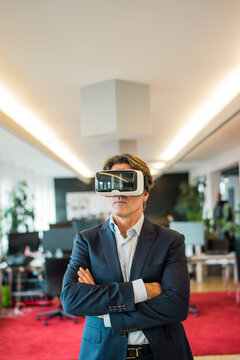 Businessman wearing VR glasses in office