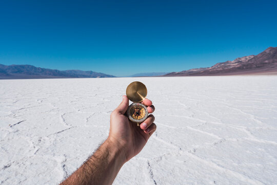 USA, California, Death Valley, man's hand holding compass