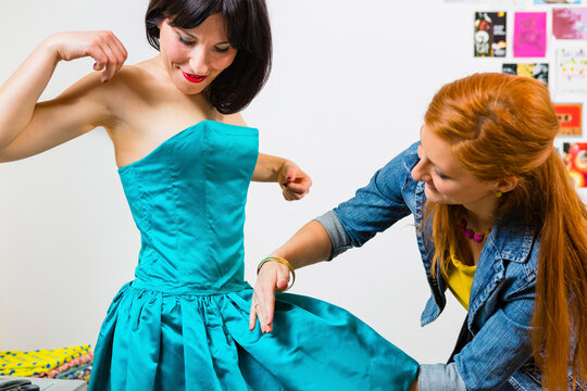 Fashion designer with client in studio
