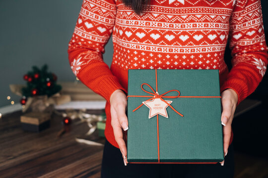 Woman's hands holding Christmas present