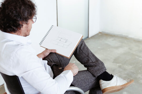 Architect sketching at construction site