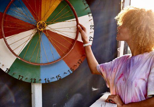 Woman turning wheel of fortune