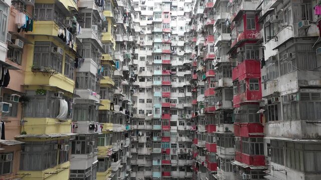 Flying backwards through colorful apartment block in famous 'Monster Building', a subsidized housing complex in Quarry Bay, Hong Kong
