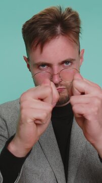 Greedy avaricious young business man showing fig negative gesture, you dont get it anyway. Rapacious, avaricious, acquisitive. Body language. Refusal fig sign. Bearded boy on isolated blue background