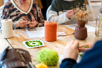 Women enjoying needlework creating crochet at home club