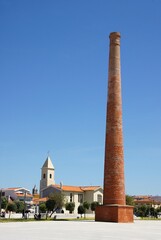 Fototapeta premium Old brick chimney standing tall in village square in Espinho, Portugal