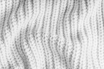 Close up, macro of crumpled white knitted fabric with visible wrinkles, folds and soft waves. Soft wool texture with detailed stitches and creases, natural textile background, fashion, design © katyamaximenko