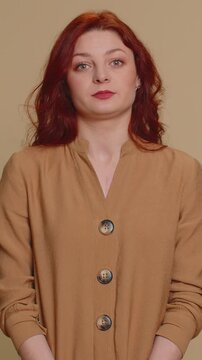 Dissatisfied redhead woman asking reason of failure, expressing disbelief irritation, feeling bored, disappointed in result, bad news. Young ginger girl isolated alone on beige studio background