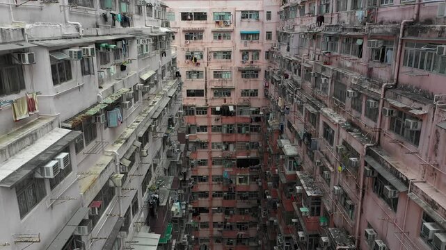 Slow drone flight through small government subsidized apartment homes in residential neighborhood in Hong Kong
