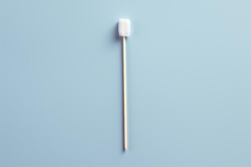 Sterile cotton swab for medical or cosmetic purposes laying on a blue background